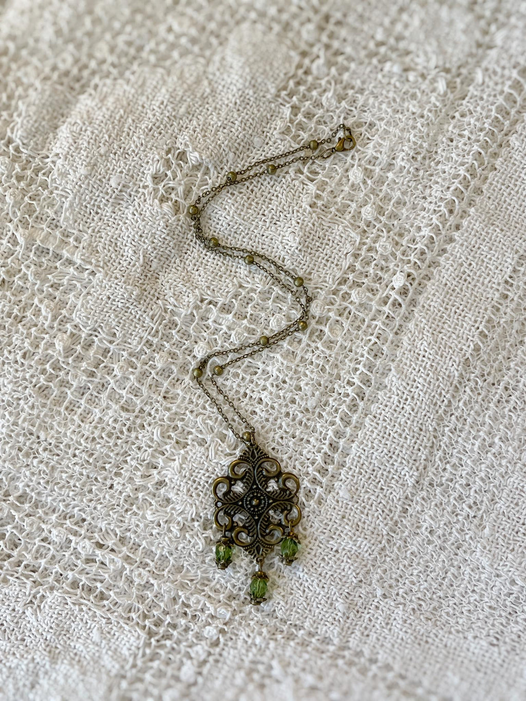 Vintage-Inspired Bronze Filigree Pendant With Green Glass Beads