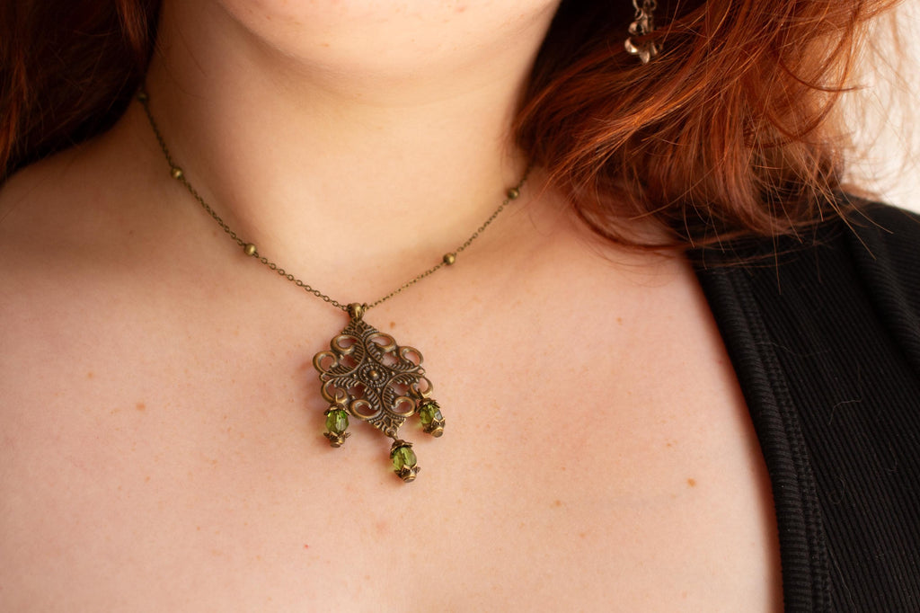 Vintage-Inspired Bronze Filigree Pendant With Green Glass Beads